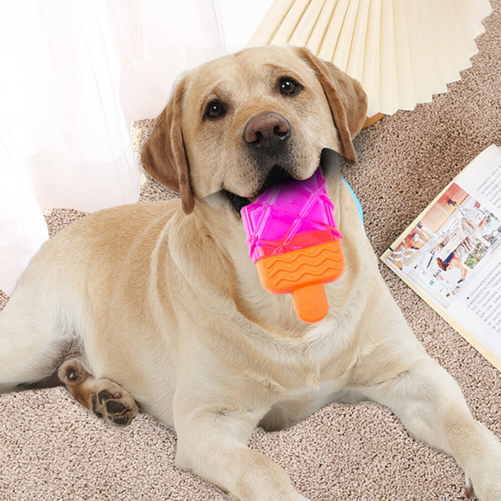 Freezable popsicle dog toy being chewed by a golden retriever puppy