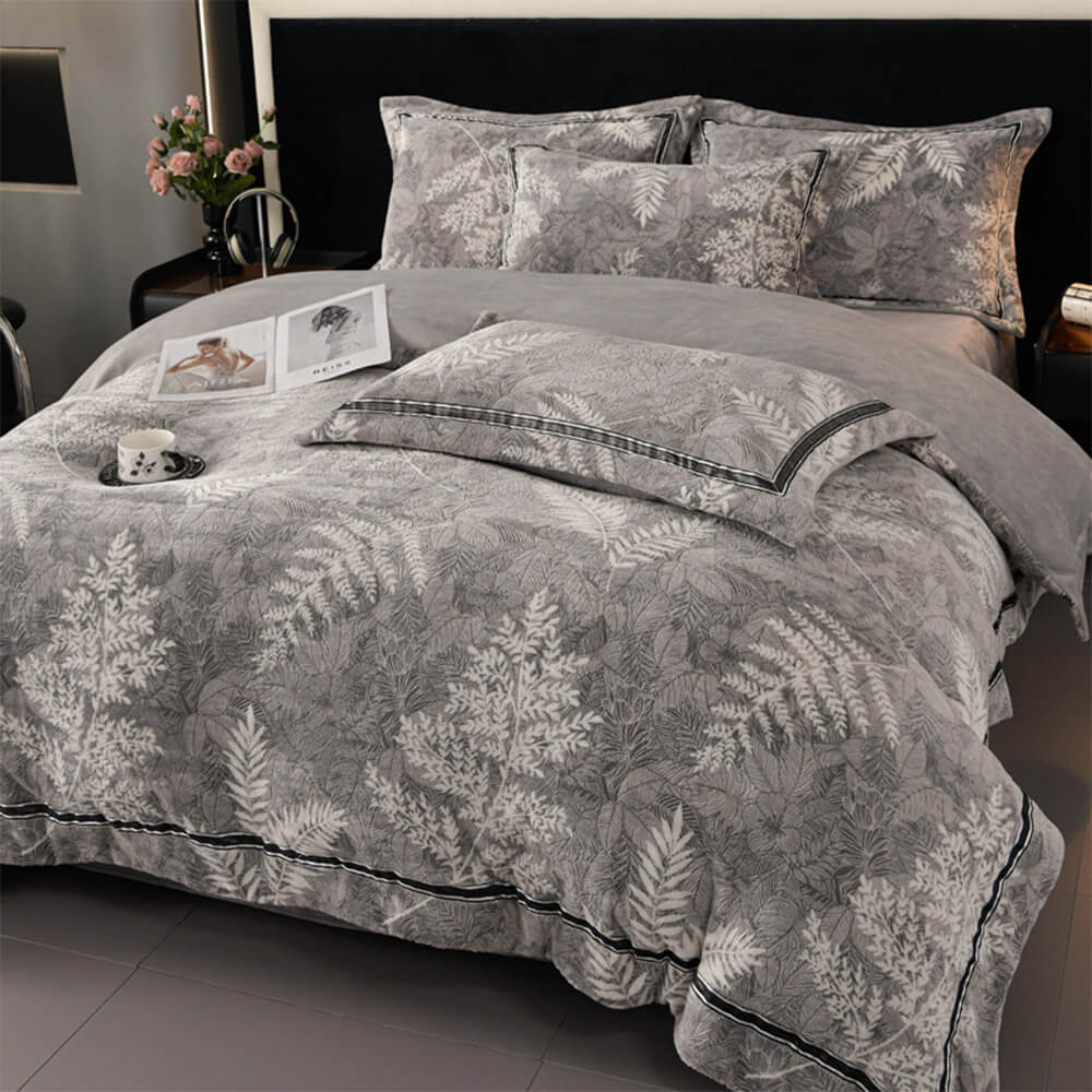 Close-up of the velvet bed sheets showcasing the soft floral ribbon trim in low light
