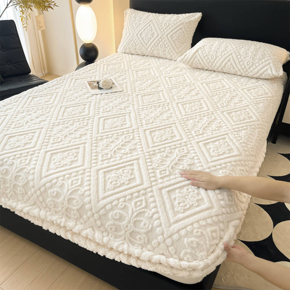 Close-up of embossed baroque pattern on milk velvet fitted sheet
