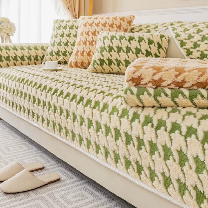 Elegant living room featuring a plush houndstooth couch cover perfectly fitted on a sofa, with a happy dog lounging comfortably.