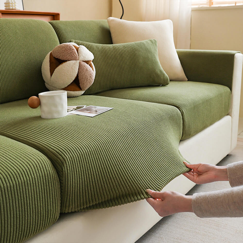 Elegant corduroy sofa protector with vertical stripes stretched smoothly over a modern grey couch, showcasing its full-cover design.