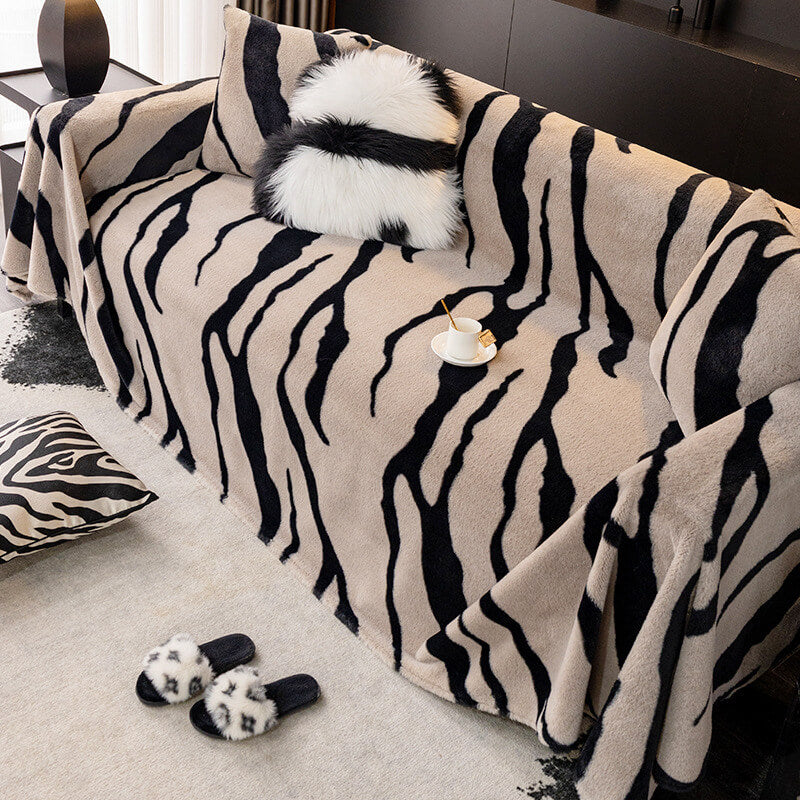Pawsome Zebra Sofa Shield plush couch cover on a sofa with pets