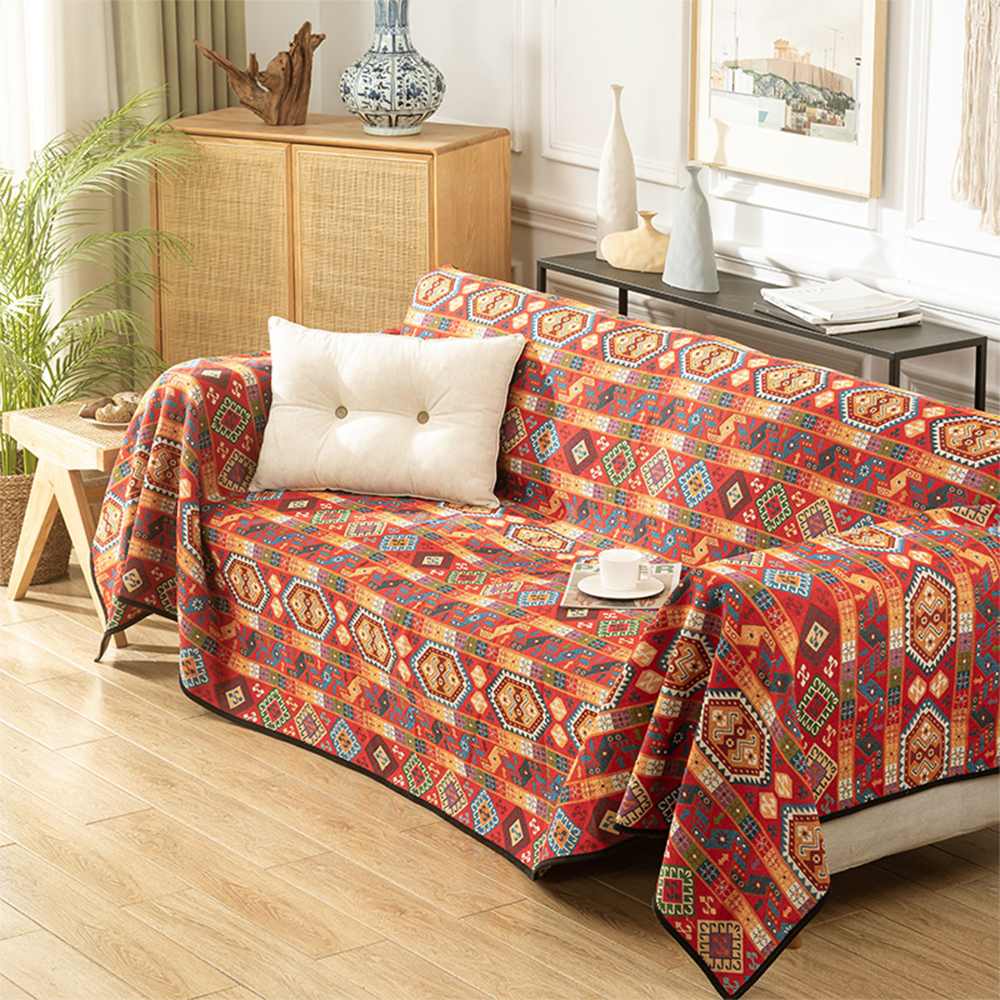 Moroccan throw blanket draped over a rustic couch in a boho-inspired living room