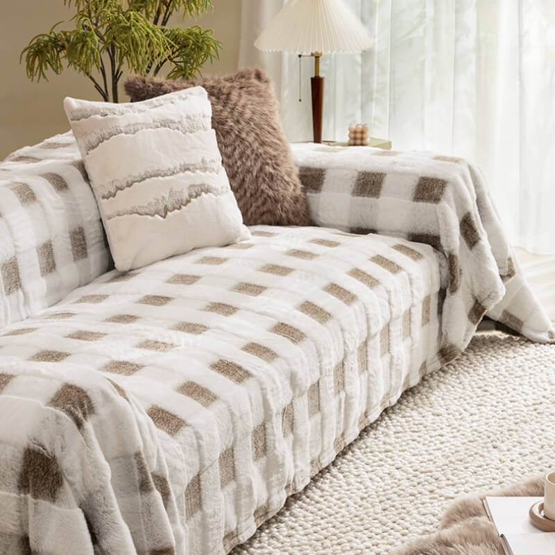 Checkerboard plush sofa protector draped over a large couch, showcasing full coverage