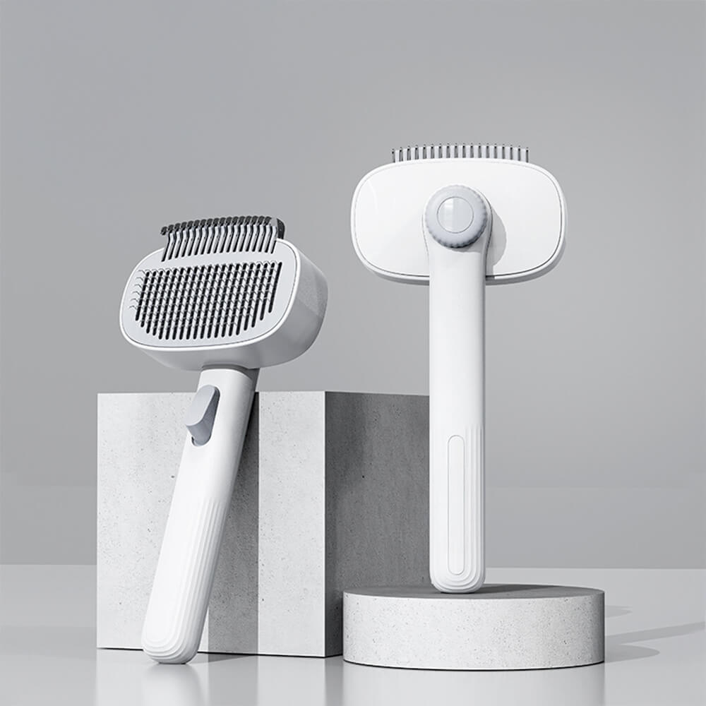 Close-up of the dual-head self-cleaning pet grooming brush showing bristles and cleaning mechanism.