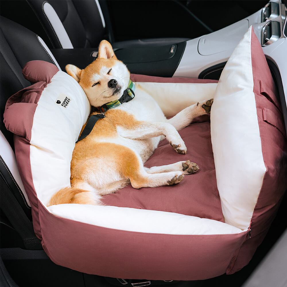 Dog car seat bed installed in a rear car seat with harness attachment visible