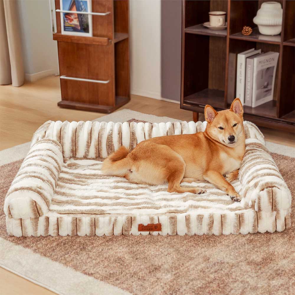 Close-up of fluffy striped orthopedic dog bed with bolsters in a cozy living room
