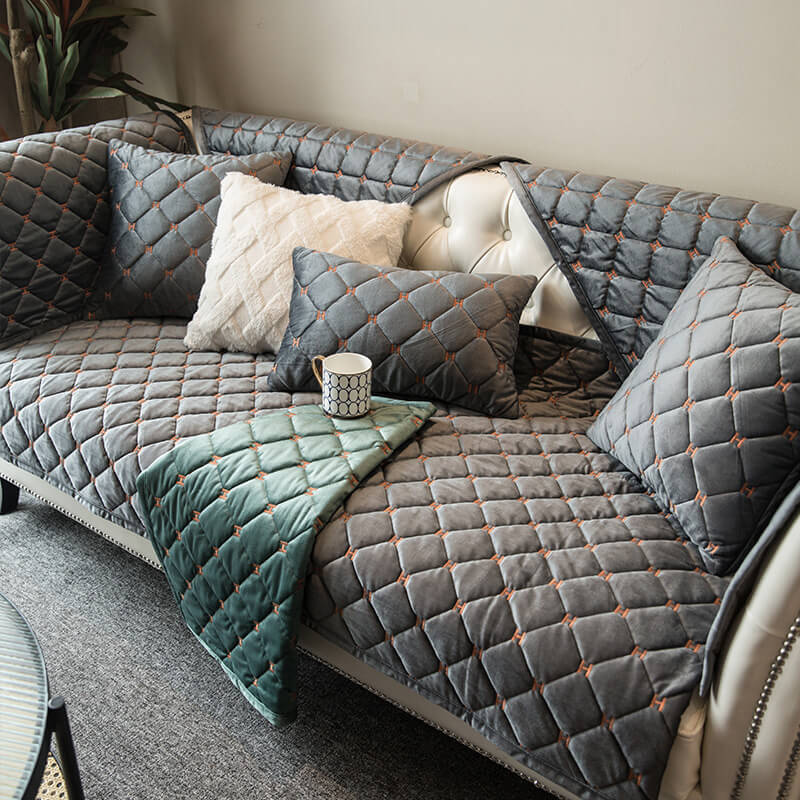 A close-up view of the opulent quilted velvet couch cover, showcasing its rich texture and precise stitching, perfect for any living room.