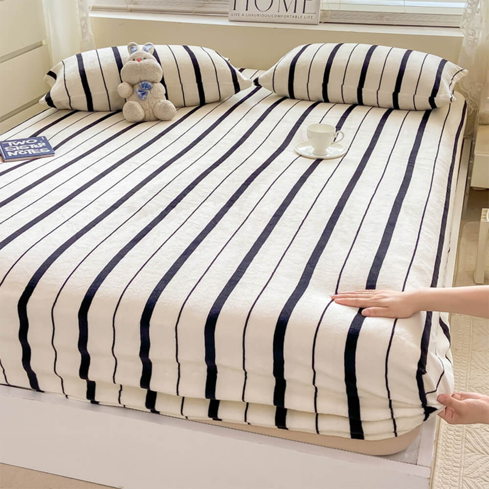 Close-up of striped milk velvet fitted sheet showing plush texture and vibrant stripes